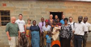 Bettina (in red scarf) outside her new house